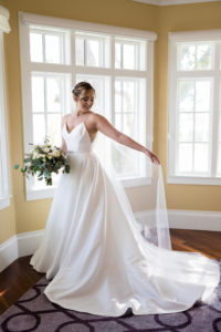 Tampa Bay Bride Beauty Portrait Wearing Justin Alexander A-Line V Neck with Straps and Rhinestone Belt Wedding Dress and Full Length Veil with Eucalyptus and Ivory Floral Bridal Bouquet