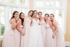 Tampa Bay Bride Wearing V Neck A-Line with Straps and Rhinestone Belt Justin Alexander Wedding Dress, Bridesmaids in Blush Pink Mix and Match Dresses