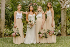 Boho Inspired Bridal Party Wedding Portrait, Bridesmaids in Mix and Match Nude and White Two Tone Colorblock Dresses Holding Round Metal Rings with King Proteas, Pink and Ivory Roses, Eucalyptus and Greenery Floral Bouquets, Bride in Boho Inspired Lace V Neckline with Spaghetti Straps Stella York Wedding Dress | Tampa Bay Wedding Hair and Makeup LDM Beauty Group