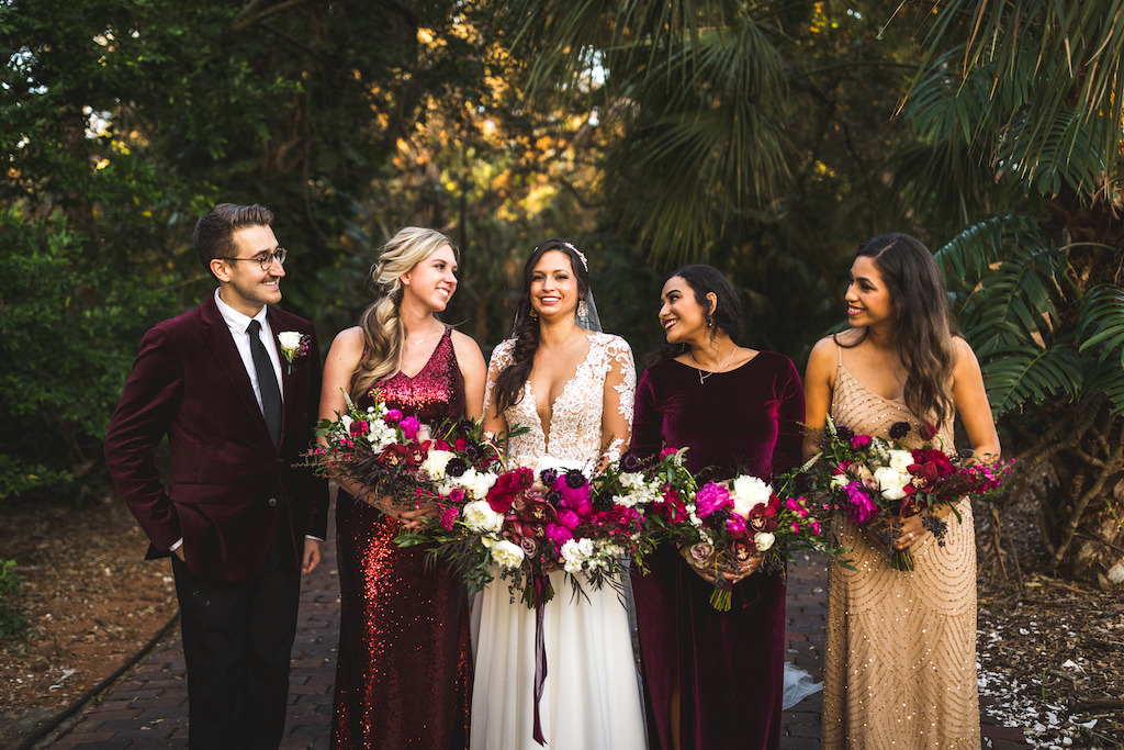INSTAGRAM Boho Chic Tampa Bay Bride in Boho Chic Chiffon A-Line V Neck Illusion Long Sleeve with Lace Appliques Wedding Dress Holding Whimsical Colorful Pink, Purple and White Floral Bouquet, Bridesmaids in Mix and Match Dresses, Gold Sparkle, Burgundy Velvet, Red Sequins, Male Friend in Velvet Burgundy Suit | Tampa Bay Wedding Hair and Makeup Femme Akoi Beauty Studio