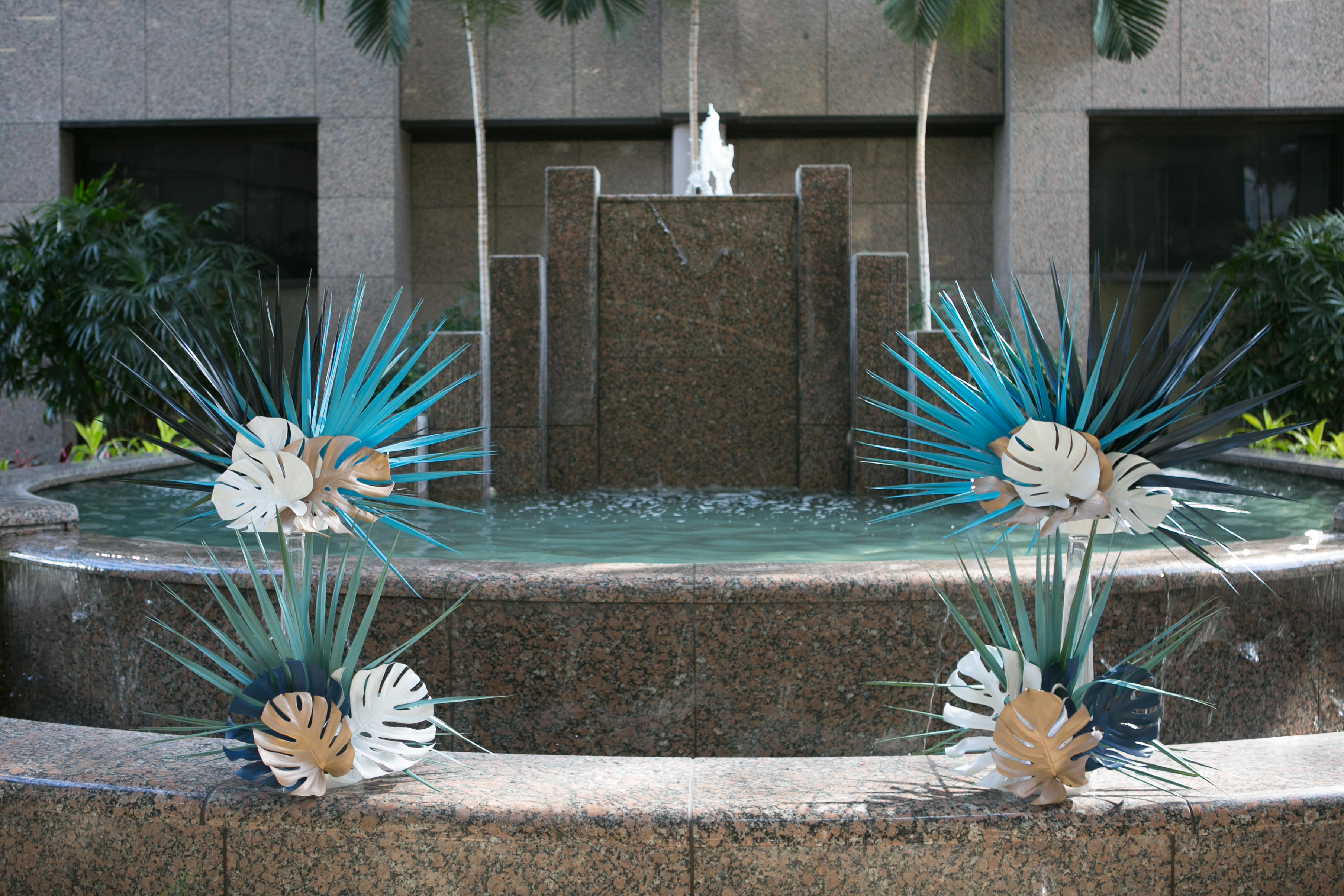 Unique Tropical Wedding Ceremony Decor, Green, Gold and Ivory Palm Tree and Monstera Leaves on Fountain | Wedding Planner John Campbell Weddings and Events | Tampa Wedding Venue Centre Club