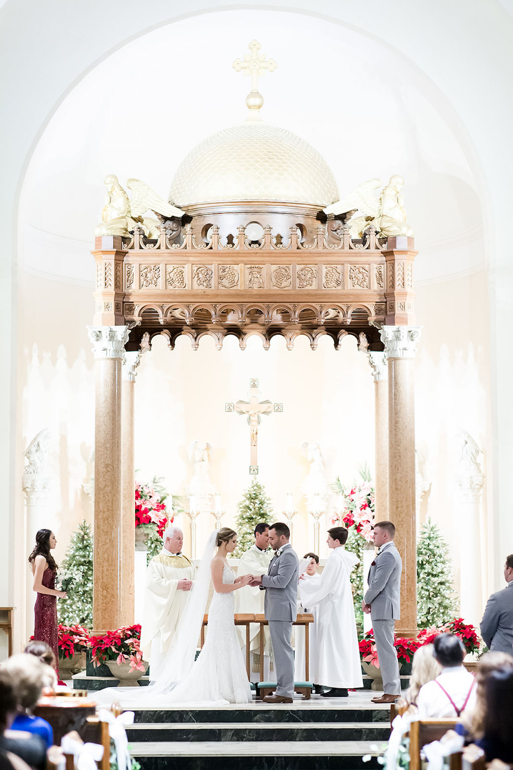 St. Petersburg Bride and Groom Exchange Vows in Catholic Wedding Ceremony, Christmas Wedding Decor | Tampa Bay Wedding Photographers Shauna and Jordon Photography