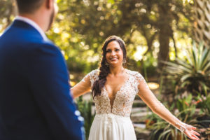 Boho Chic Tampa Bay Bride and Groom First Look Wedding Portrait in A-Line Chiffon and Illusion Long Sleeve with Lace Applique V Neckline Wedding Dress, Side Braid Hair | Wedding Hair and Makeup Femme Akoi Beauty Studio