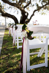 Simple Classic Wedding Ceremony Decor with White Folding Chairs, White Rose with Green Leaves and Burgundy Accent | Tampa Bay Wedding Planner Coastal Coordinating
