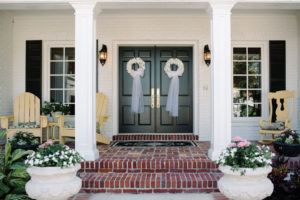 Black Doors with White Floral Wreaths and Tulle Bows Hanging