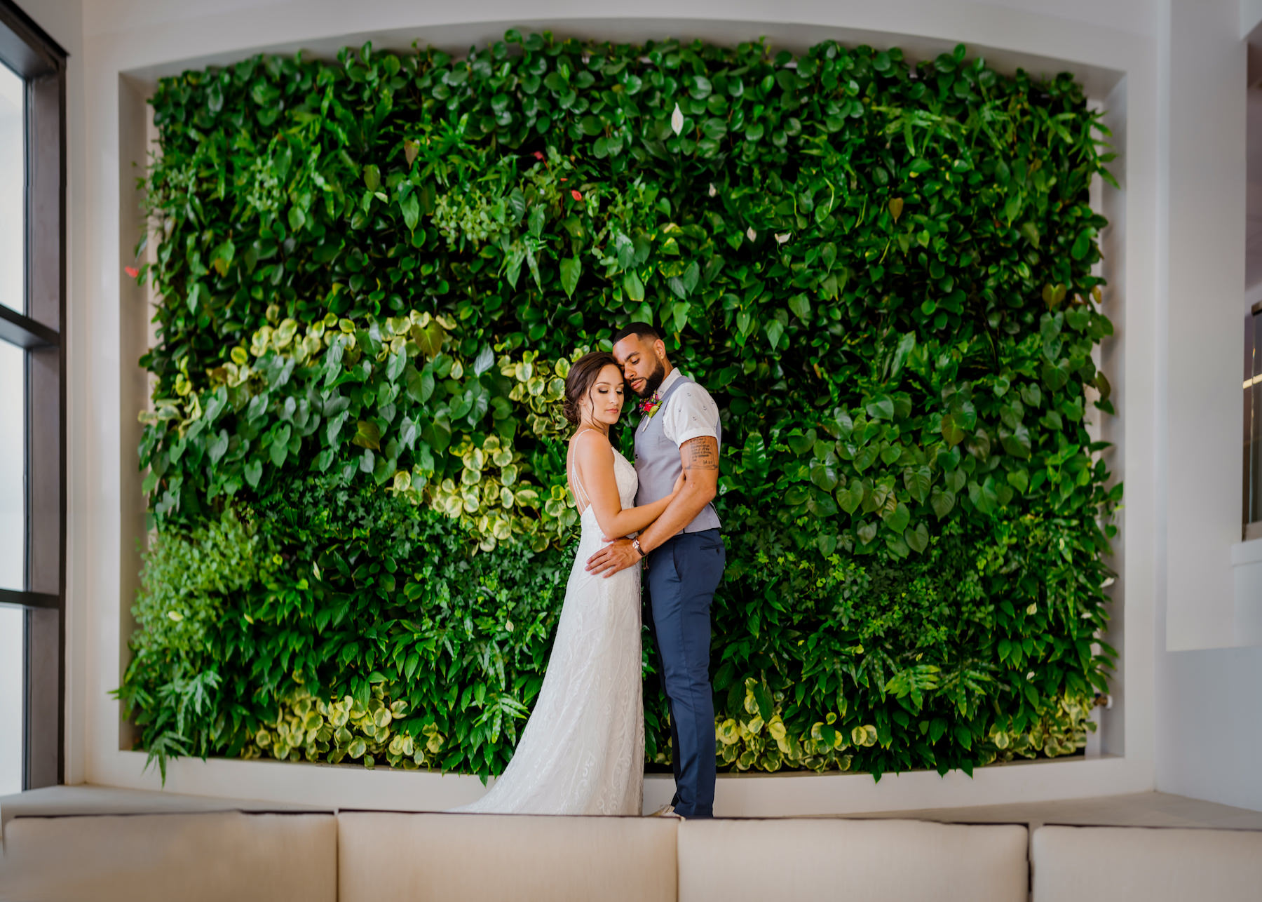 Intimate Bride and Groom First Look Wedding Portrait In Front of Greenery Hotel Backdrop | Tampa Bay Waterfront Beach Hotel Wedding Venue Hilton Clearwater Beach