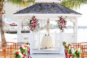 Tropical Romantic Wedding Ceremony Decor, White Gazebo with Pink, White, Fuschia and Greenery Floral Arrangements | Tampa Bay Wedding Photographer Lifelong Photography Studios | St. Pete Waterfront Wedding Venue Isla Del Sol Yacht and Country Club