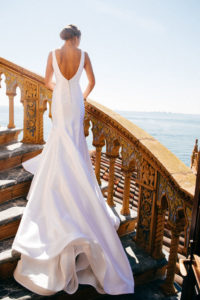 Bride in Classic Silhouette Open Back Wedding Dress on Staircase at Waterfront Sarasota Wedding Venue Ca d’Zan at The Ringling Museum | Tampa Bay Wedding Hair and Makeup Femme Akoi Beauty Studio