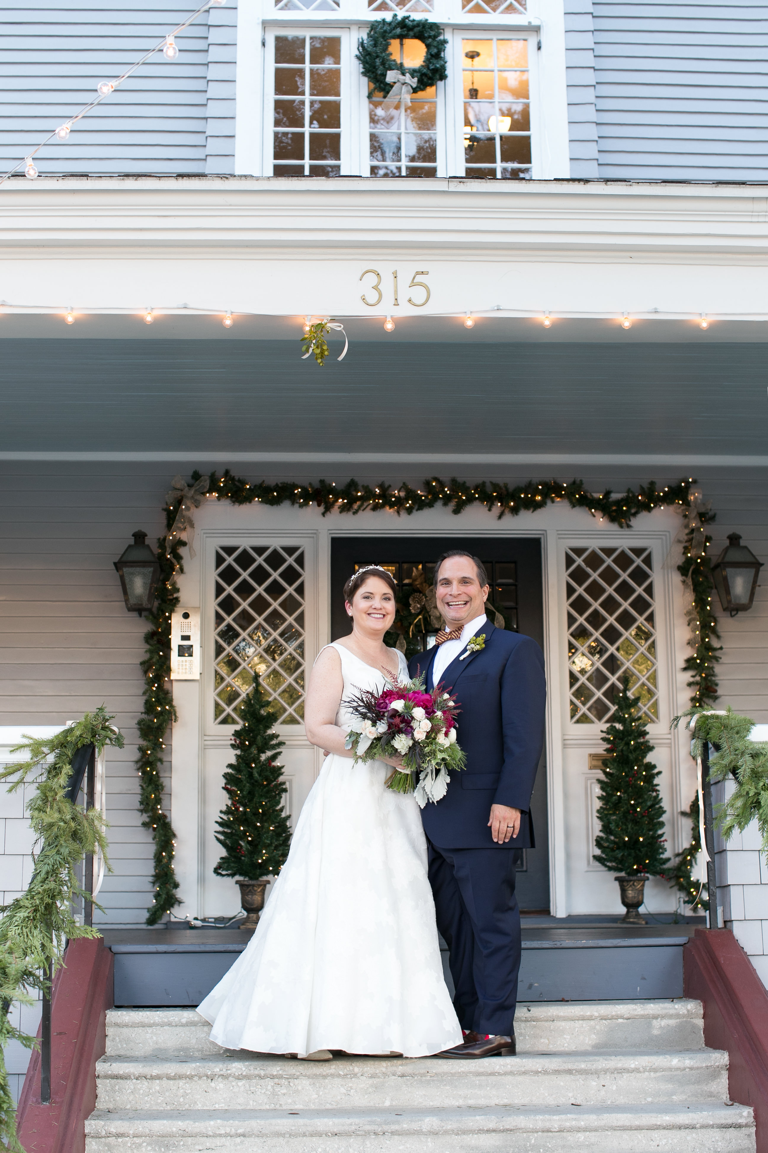Christmas Wedding Reception Decor, Garland with Lights Around Door of Wedding Venue The Orlo House, Bride and Groom Wedding Portrait | Tampa Bay Wedding Photographer Carrie Wildes Photography