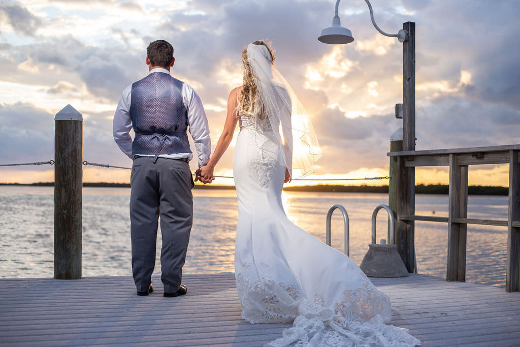 Romantic Sunset Waterfront Pier Tampa Bay Bride and Groom Wedding Portrait, Bride in Fitted Lace Open Back with Spaghetti Straps Maggie Sottero Wedding Dress