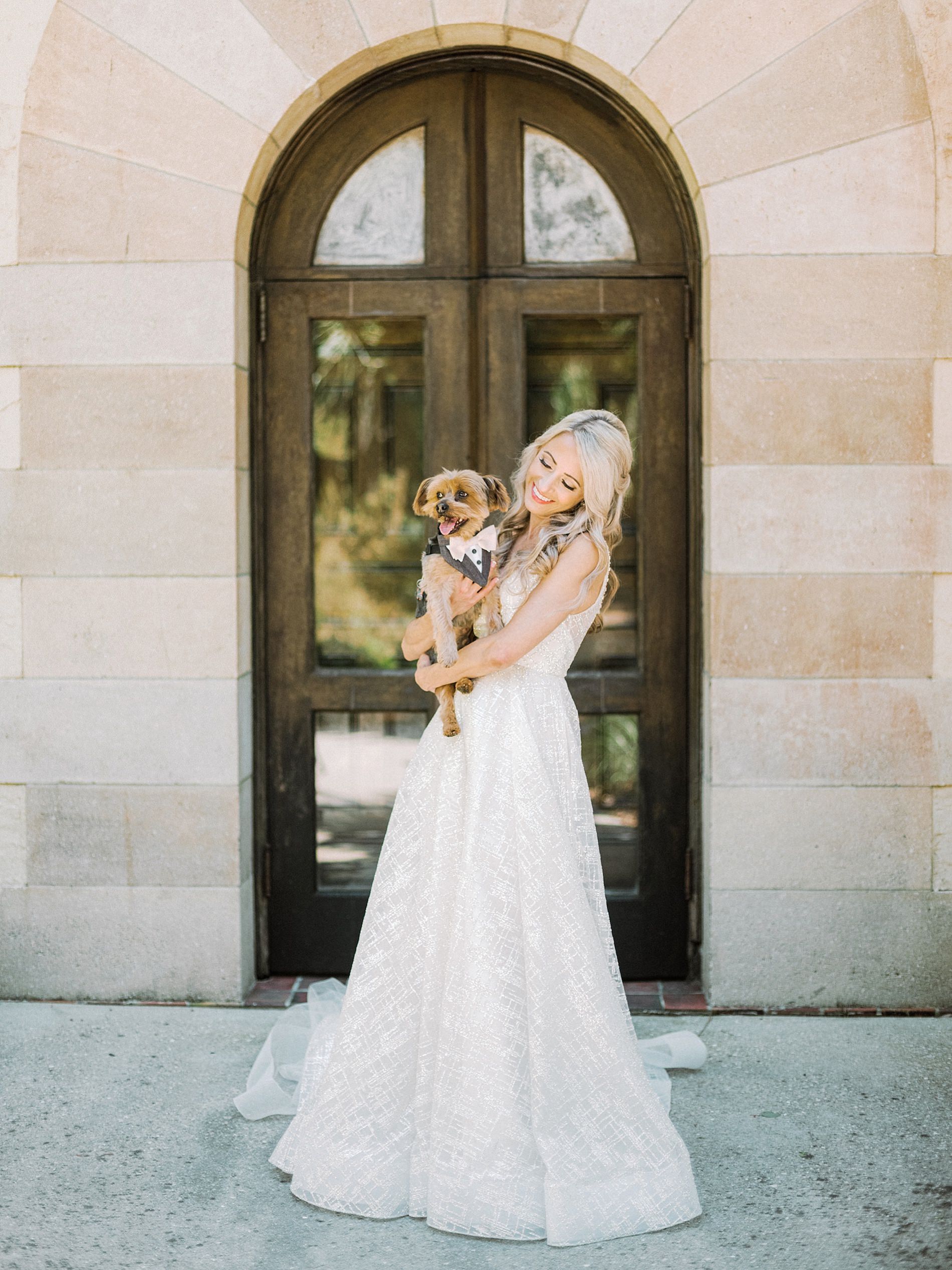 Sarasota Bride in Romantic Lazaro Ballgown Wedding Dress Holding Dog in Tuxedo