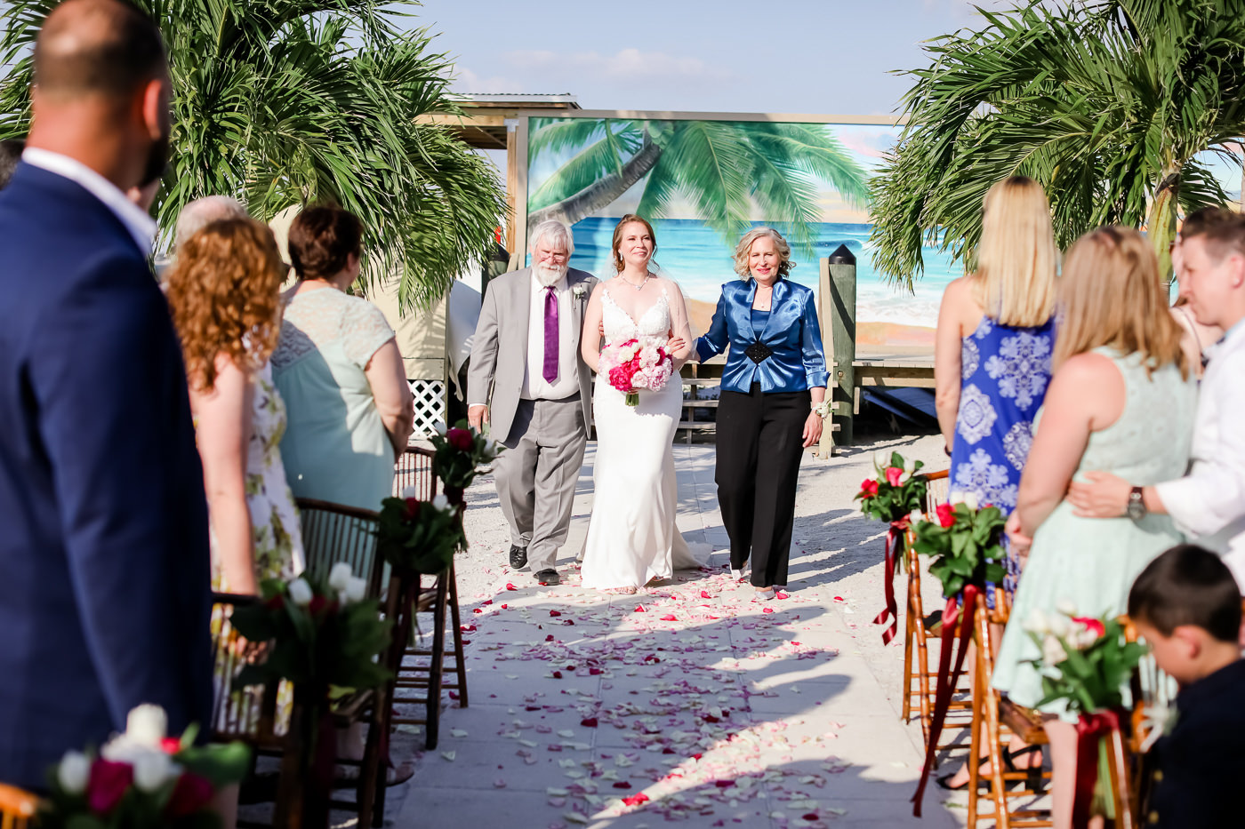 Tropical Florida Bride with Mother and Father Walking Down the Aisle Wedding Ceremony Portrait | St. Pete Beach Wedding Photographer Lifelong Photography Studios | St. Pete Waterfront Wedding Venue Isla Del Sol Yacht and Country Club