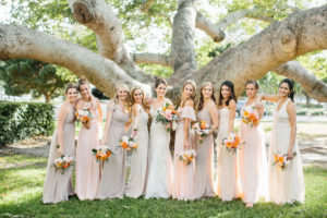 Romantic Bridal Party Portrait, Bridesmaids Wearing Mix and Match Blush Pink, Neutral and Champagne Dresses Holding Whimsical Orange and Pink Roses with Greenery Floral Bouquets, Bride in Lace and Illusion Neckline Fit and Flare Watters Wedding Dress | St. Petersburg Wedding Hair and Makeup Femme Akoi Beauty Studio | Tampa Bay Wedding Florist Bruce Wayne Florals