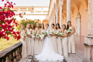 Classic Bride Holding White Orchids and Roses with Greenery Floral Bouquet and Bridesmaids in Neutral Champagne Cream Mix and Match Dresses Bridal Party Portrait at Sarasota Wedding Venue Ca d’Zan at The Ringling Museum | Tampa Bay Wedding Hair and Makeup Femme Akoi Beauty Studio | Sarasota Wedding Planner NK Productions