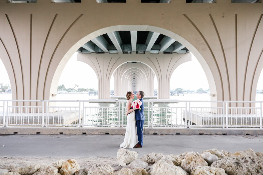 St. Petersburg Bride and Groom Under Bridge Wedding Portrait | Tampa Bay Wedding Photographer Lifelong Photography Studios | Waterfront Wedding Venue Isla Del Sol Yacht and Country Club