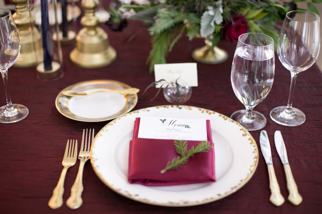 Christmas Inspired Wedding Reception Decor, Gold Rimmed Plates, Burgundy Linens, Gold Flatware | Tampa Bay Wedding Photographer Carrie Wildes Photography
