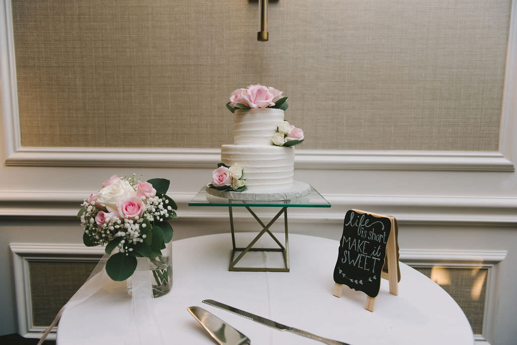 Classic Two Tier White Ruffled Wedding Cake Garnished with Blush Pink Roses, Chalkboard Make It Sweet Sign, Vase with White and Blush Pink Roses, White Baby's Breathe and Eucalyptus, Dessert Table | Tampa Bay Wedding Photographer Kera Photography | St. Petersburg Wedding Reception Venue Red Mesa Events
