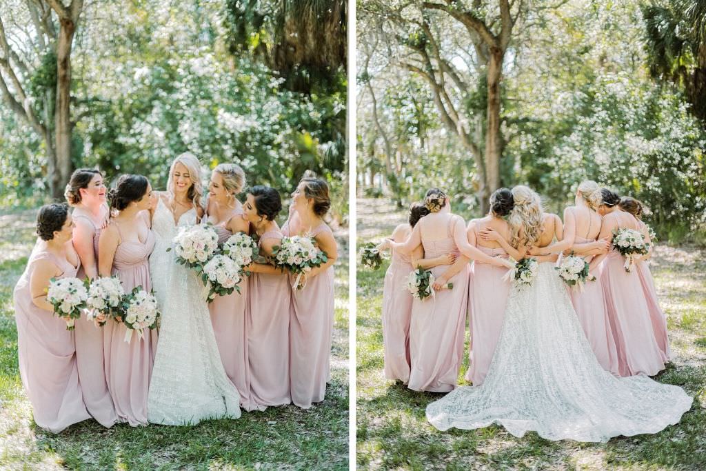 Elegant Bride in Lazaro V-Neck Ballgown Wedding Dress with Bridesmaids in Blush Pink Dresses Holding White Roses and Anemone with Greenery Floral Bouquets Portrait