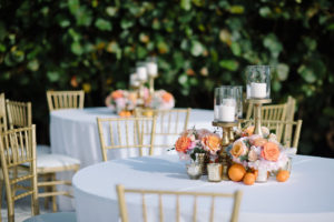 Whimsical Romantic Wedding Reception Decor, Round Tables with White Linens, Gold Chiavari Chairs, Blush Pink Peonies, Orange Roses in Gold Vases Small Centerpieces, Tall Gold Candlesticks and Orange Fruits | Tampa Bay Wedding Florist Bruce Wayne Florals | St. Pete Wedding Rentals Gabro Event Services
