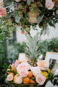 INSTAGRAM Whimsical Wedding Reception Decor, Blush Pink Roses with Oranges, Lemons and Pineapple Fruit in Bowl, Tall Gold Candlestick with Hydrangeas and Greenery Floral Arrangement | Tampa Bay Wedding Florist Bruce Wayne Florals