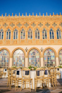 Classic Elegant Wedding Reception Decor, Round Tables with White Tablecloths and Navy Blue Linens, Gold Chairs, White and Greenery Floral Low Centerpieces | Sarasota Historic Waterfront Wedding Venue Ca d’Zan at The Ringling Museum | Tampa Bay Wedding Planner NK Productions