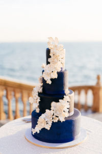 INSTAGRAM Four Tier Navy Blue Wedding Cake with Cascading White and Gold Sugar Flowers