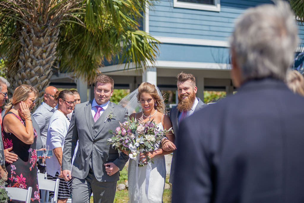 Tampa Bay Easter Spring Bride Walking Down the Aisle Wedding Ceremony Portrait Holding Organic Lilac, Purple, White and Greenery Floral Bouquet