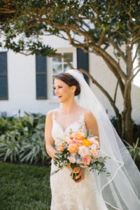 Romantic Florida Bride Beauty Portrait Wearing Lace and Illusion Neckline Watters Wedding Dress with Full Length Veil Holding Whimsical Orange and Blush Pink Roses, Dusty Miller Leaves, Eucalyptus Floral Bridal Bouquet | Tampa Bay Wedding Florist Bruce Wayne Florals | St. Pete Wedding Hair and Makeup Femme Akoi Beauty Studio