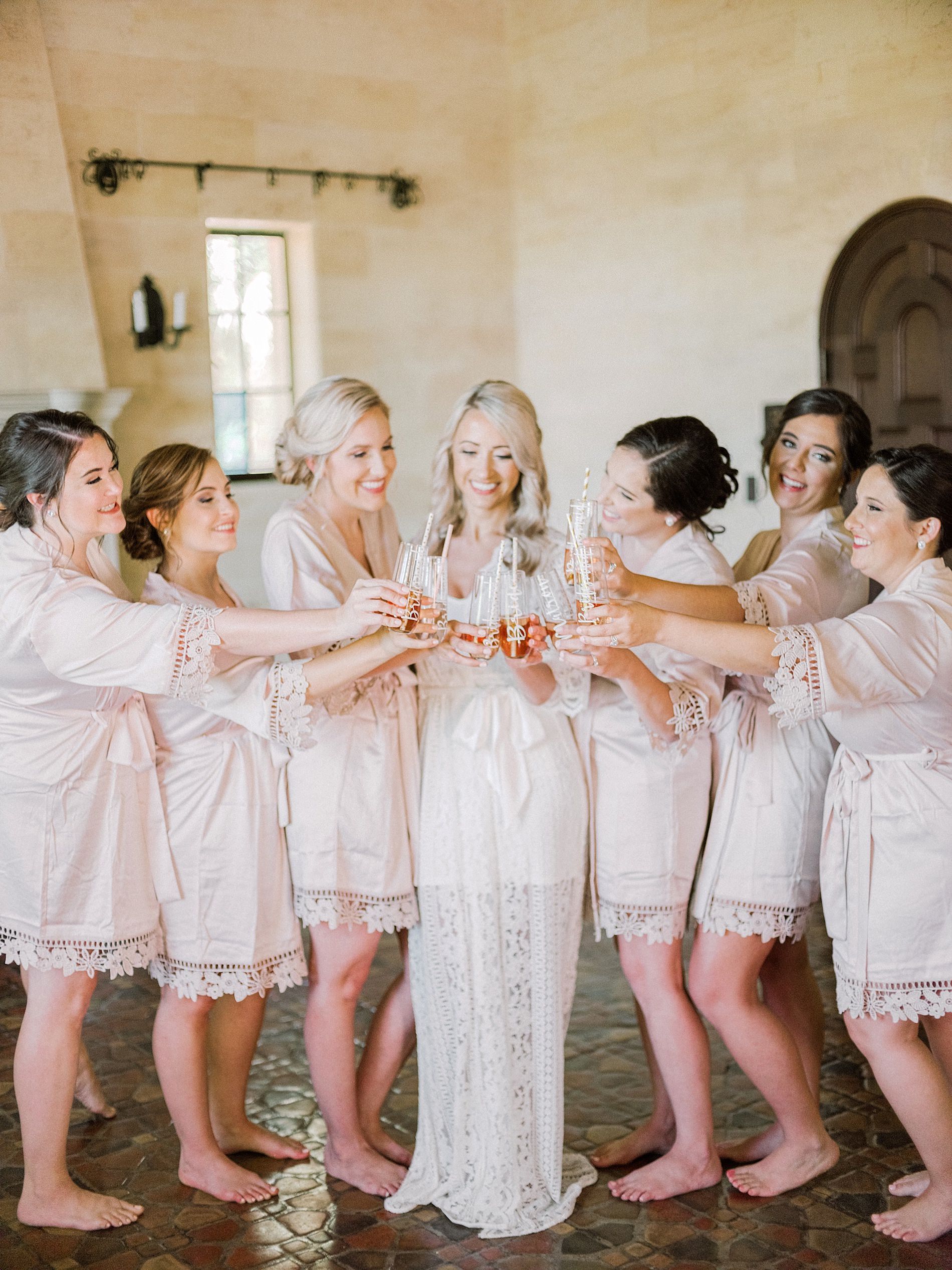 Romantic Bride with Bridesmaids in Blush Pink Robes Champagne Toast Wedding Portrait