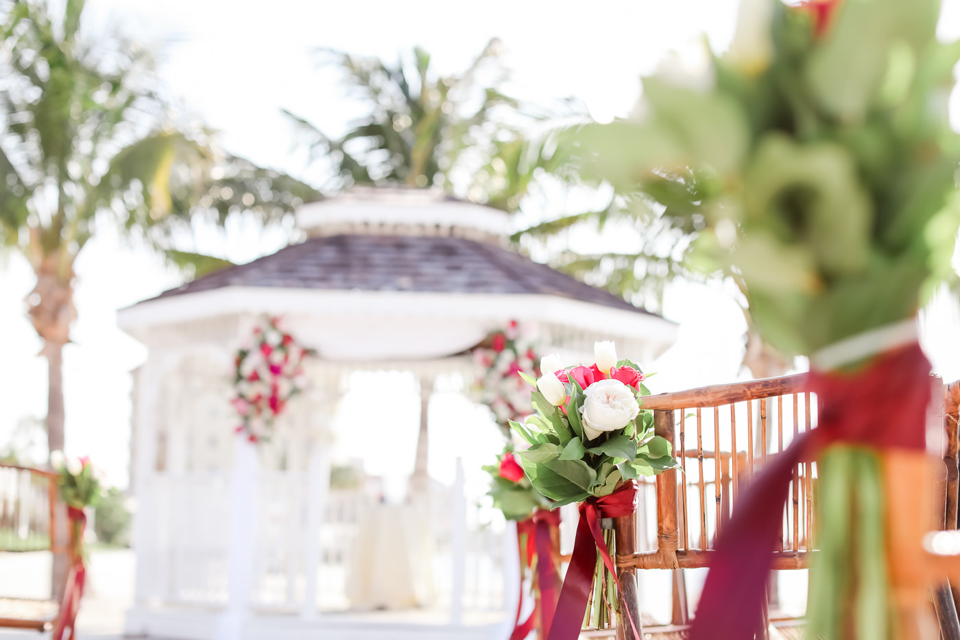 Tropical Wedding Ceremony Decor, White Tulips, Red and Greenery Floral Arrangements | Tampa Bay Wedding Photographer Lifelong Photography Studios | Waterfront St. Pete Wedding Venue Isla Del Sol Yacht and Country Club
