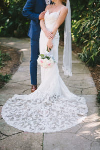 St. Petersburg Groom and Bride Wearing Romantic Lace V Neckline with Spaghetti Straps and Elegant Lace Train Wedding Dress Holding White and Blush Pink Roses Classic Floral Round Bridal Bouquet Garden Wedding Portrait | Tampa Bay Wedding Photographer Kera Photography | Wedding Dress Shop Truly Forever Bridal