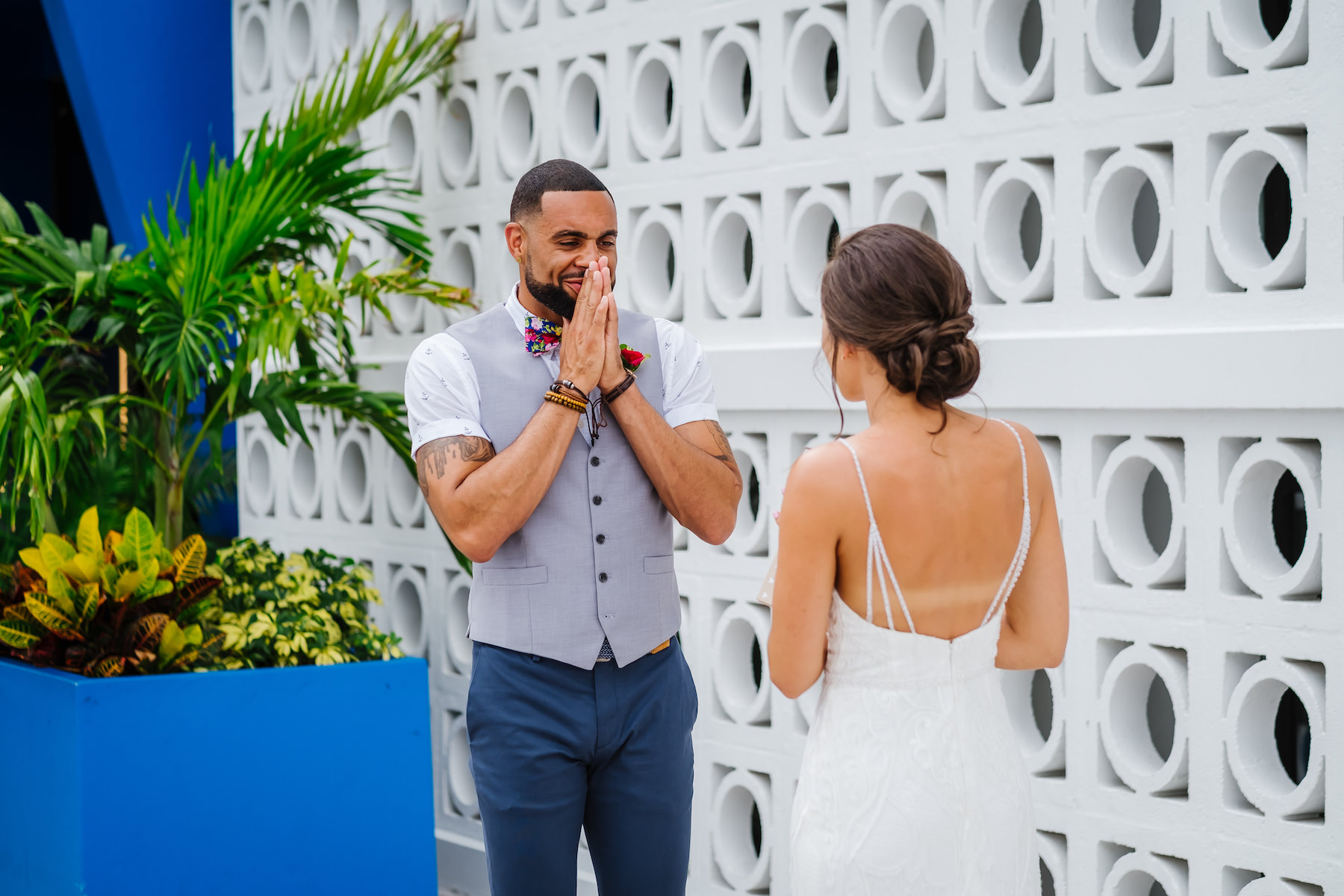 Tropical Florida Bride and Groom Intimate Emotional First Look Wedding Portrait, Groom in Grey Vest and Blue Pant Suit, Short Sleeve White Shirt and Floral Bowtie
