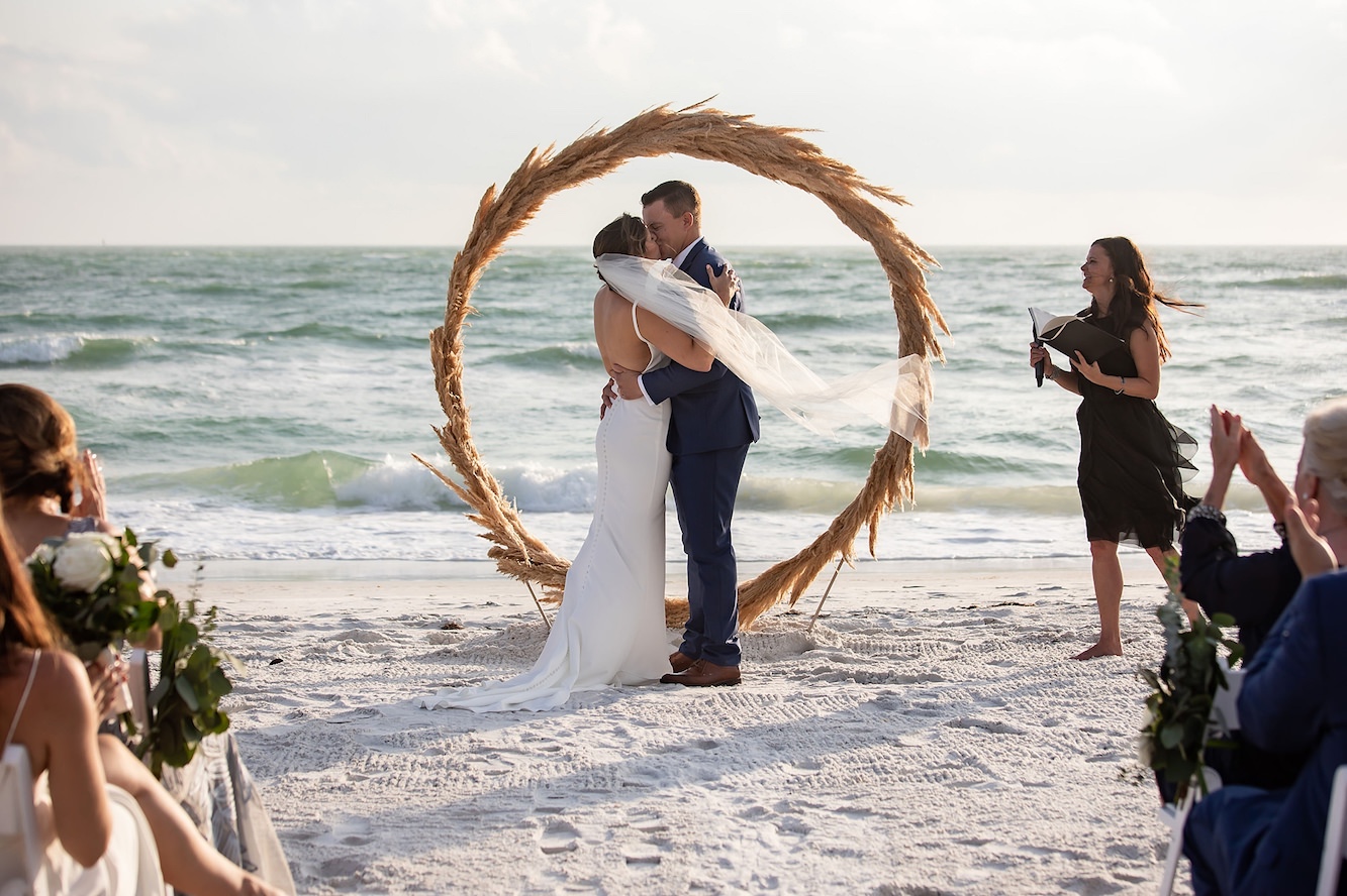 Tropical Bohemian Outdoor Florida Beach Wedding Ceremony with Straw Circular Geometric Ceremony Arch | Sarasota Wedding Venue Longboat Key Club