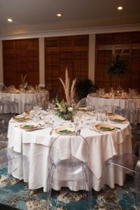 Boho Florida Wedding Reception Decor with Straw Centerpieces and Clear Ghost Chairs