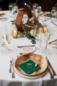 Boho Florida Wedding Reception Decor with Wooden and Greenery Centerpieces with Bamboo Plates and Personalized Dog Monogram Napkins