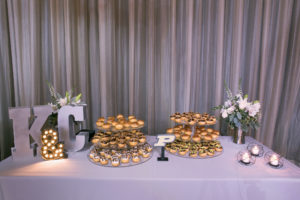 Three Tier Dishes of Cream Puffs Dessert Table on Silver Linen with Large Metal K & C Letters | Tampa Bay Wedding Photographer Carrie Wildes Photography | Wedding Planner Love Lee Lane
