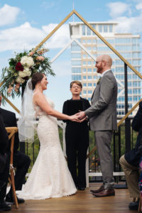 St. Petersburg Florida Wedding Venue | St. Pete Red Mesa Events | Rooftop Geometric Gold Ceremony Arch Backdrop | Lace Bridal Gown | Groom Grey Suit