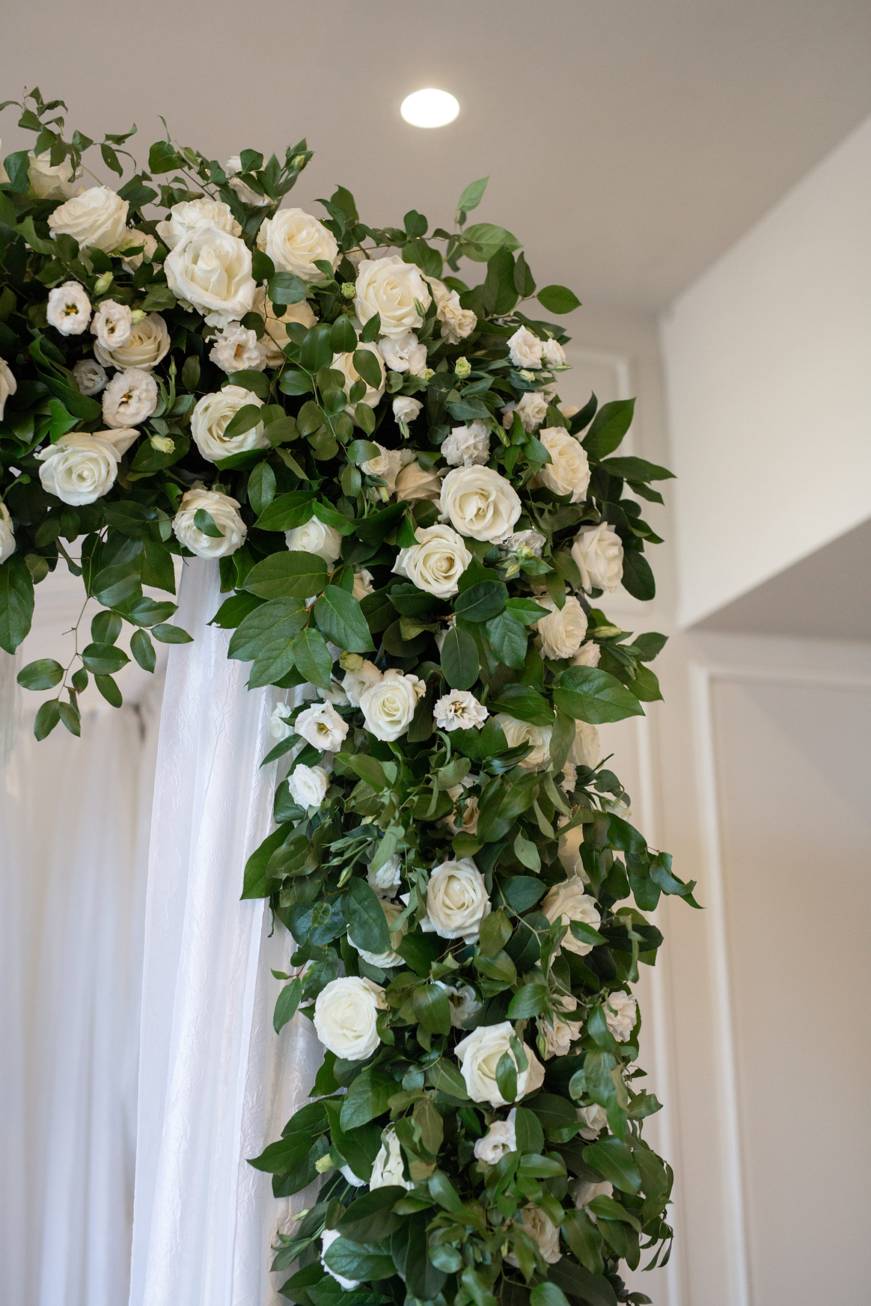 Classic Wedding Ceremony Arch Decor, White Draping with Green Leaves and Ivory Roses | Tampa Bay Wedding Planner UNIQUE Weddings + Events