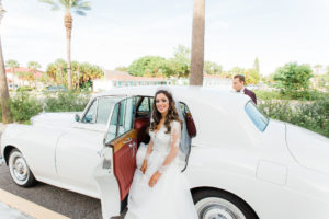 Elegant Bride Wearing Hayley Paige Wedding Dress with Lace Long Sleeve Cover with Vintage White Car
