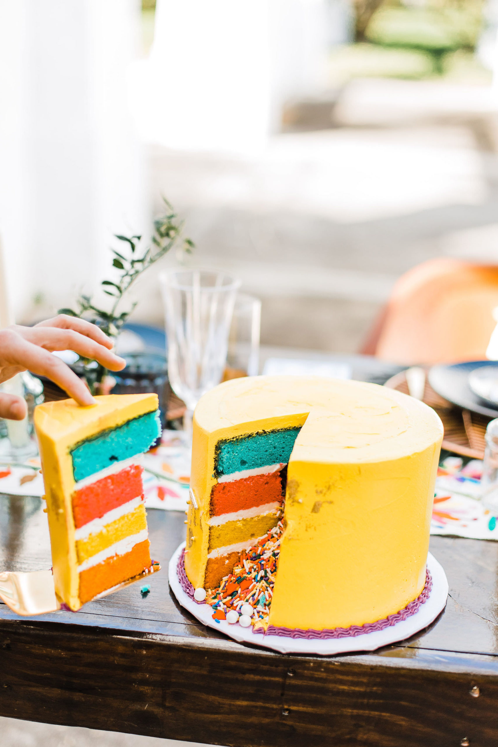 Yellow Four Tiered Colorful Confetti Sprinkle Explosion Cake with Rainbow Accents | Wandering Whisk Bakeshop