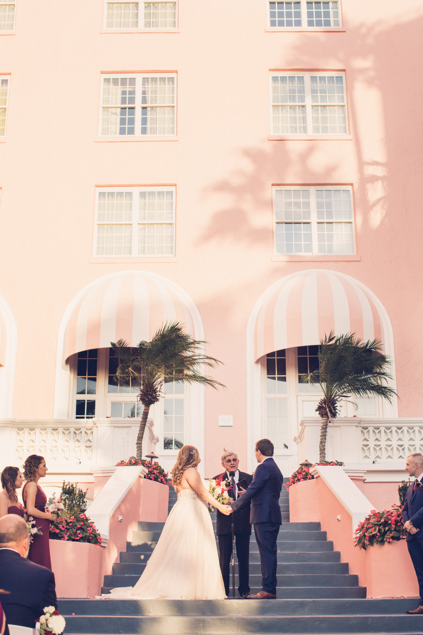 Tampa Bay Bride and Groom Exchanging Wedding Vows Ceremony Portrait at Historic St. Pete Pink Palace Courtyard Stairs The Don CeSar | Wedding Photographer Luxe Light Images