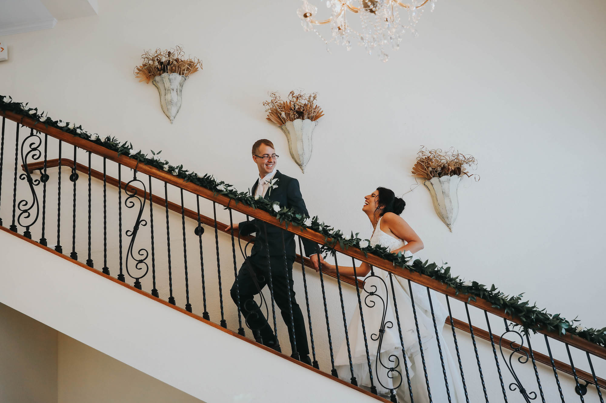 Florida Bride and Groom Go Upstairs During Wedding Reception | Tampa Bay Wedding Venue Beso Del Sol Resort in Dunedin