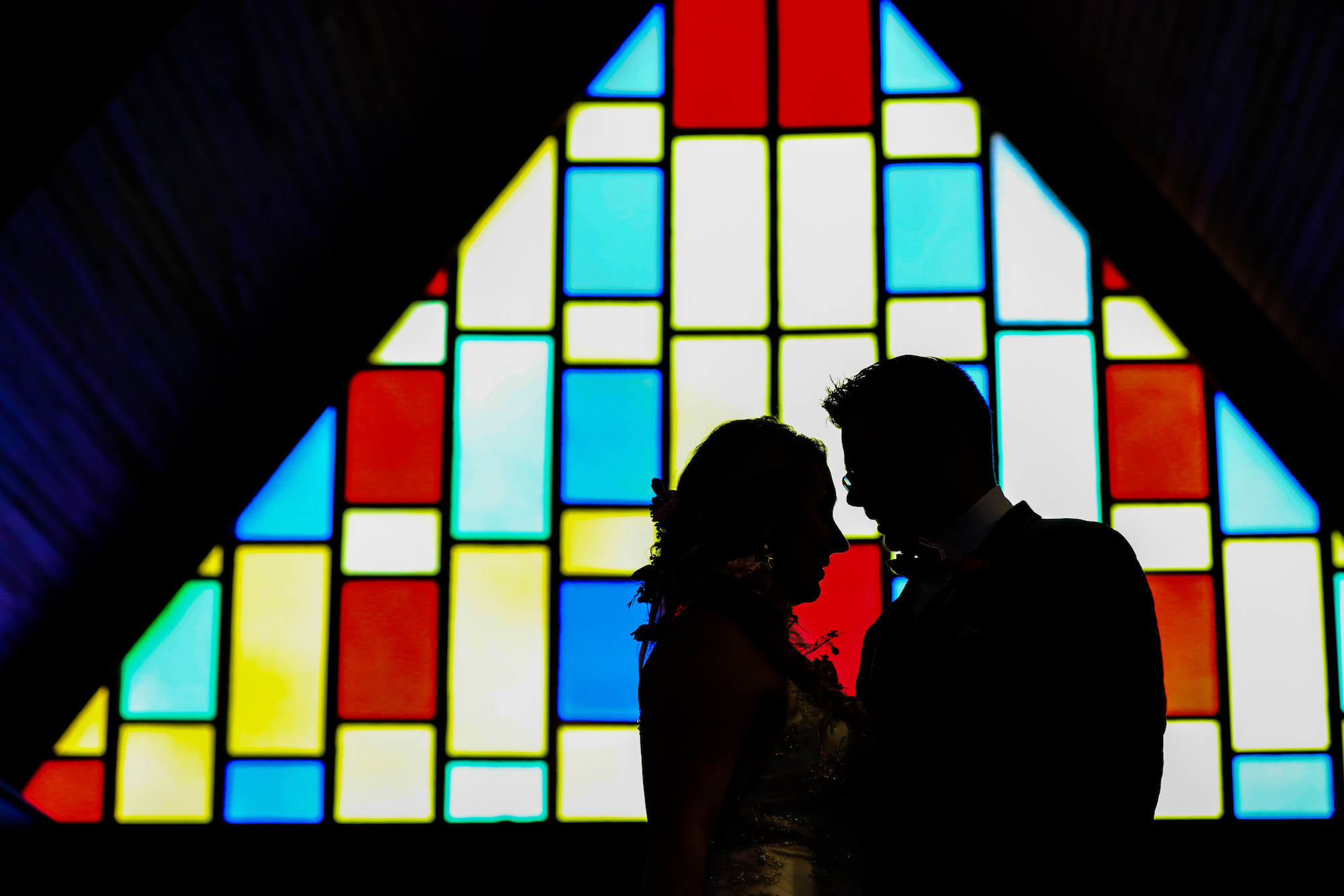 Florida Bride and Groom Silhouette with Church Stain Glass Backlight | Florida Wedding Photographer Lifelong Photography Studios