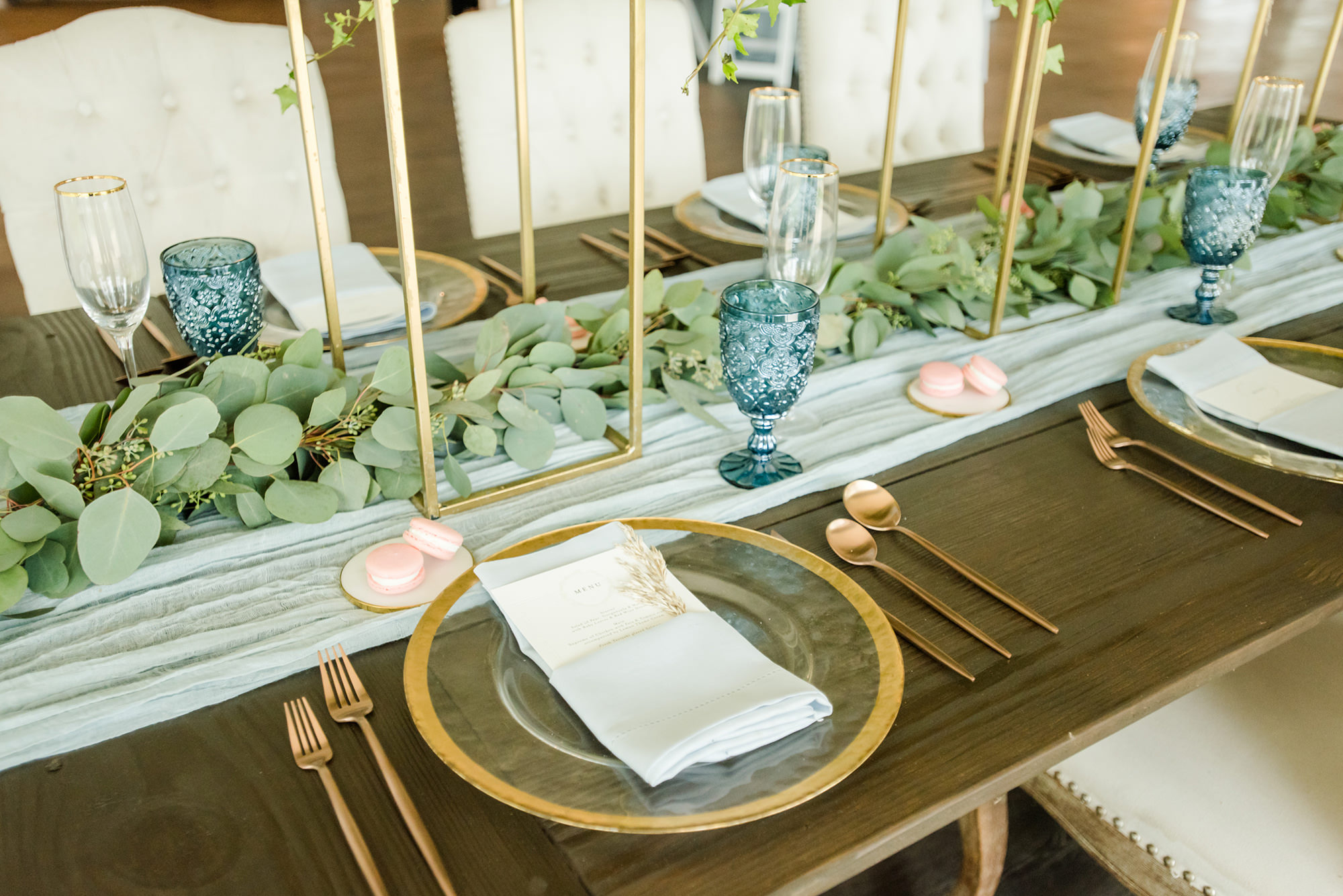 Dusty Rose Styled Wedding Shoot, Clear Glass and Gold Rimmed Chargers, White Linens with Custom Stationary, Eucalyptus Greenery Garland and White Fabric Table Runner, Blue Wine Glasses, Rose Gold Flatware, Pink Macaroons | Tampa Bay Wedding Planner Elegant Affairs by Design