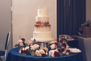 Classic Elegant Four Tier White with Painted Rose Gold Accent and Custom Cake Topper, Blush Pink Roses, Burgundy Flowers and Greenery Floral Arrangements | Wedding Photographer Luxe Light Images | Tampa Bay Wedding Cake The Artistic Whisk