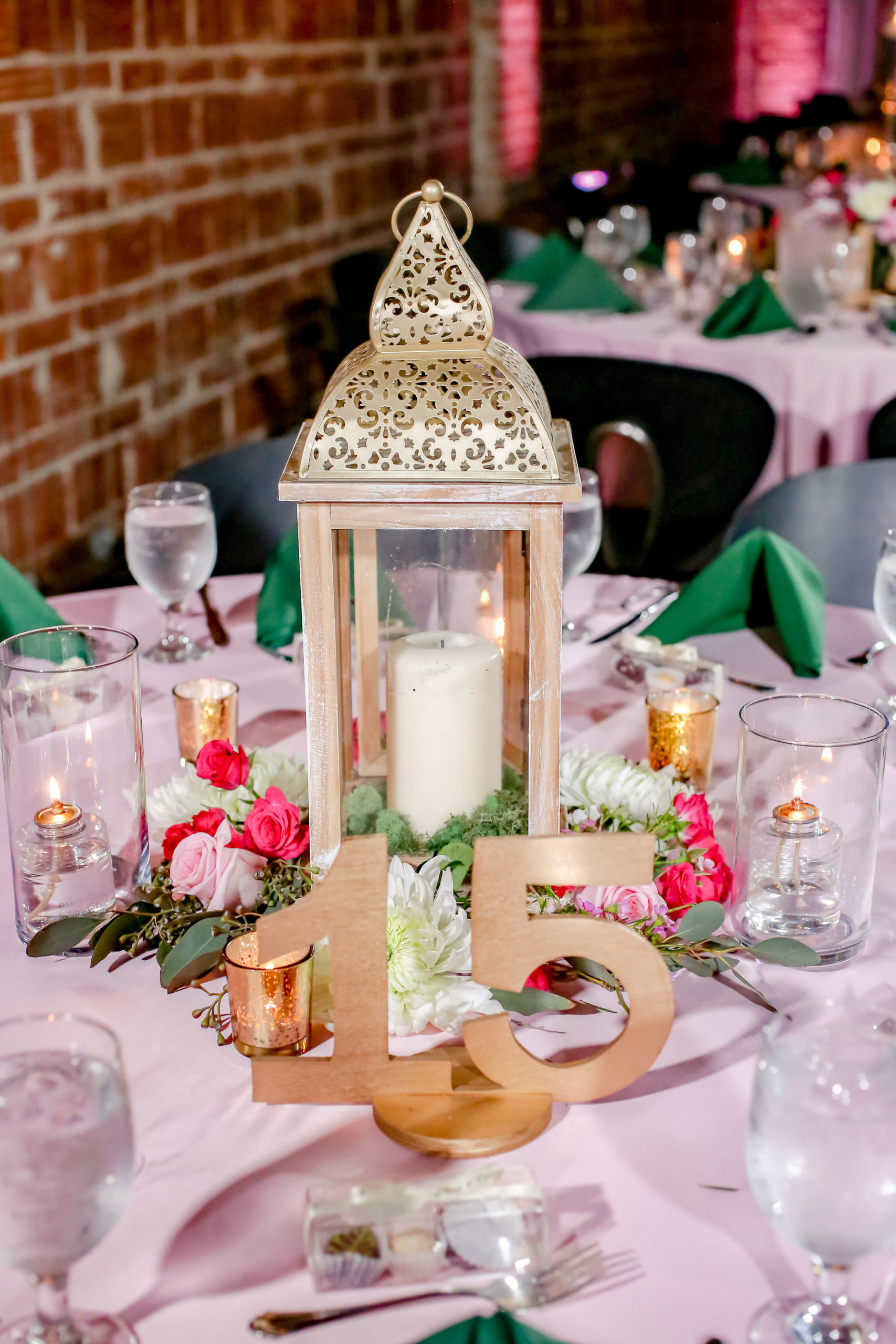 Vintage Inspired Wedding Decor at Reception, Round Tables with St. Patrick's Day Wedding Theme, Dusty Rose, Blush Pink Linens, Emerald Green Napkins, Ivory and and Red Florals with Candles, Wooden Table Numbers | Florida Wedding Photographer Lifelong Photography Studios | Tampa Bay Unique Wedding Venue NOVA 535 in Downtown St. Pete