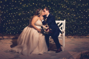 Romantic Bride and Groom Wedding Portrait with Twinkle Lights Greenery Backdrop | Wedding Photographer Luxe Light Images | Historic Pink Palace St. Pete Waterfront Wedding Venue The Don CeSar