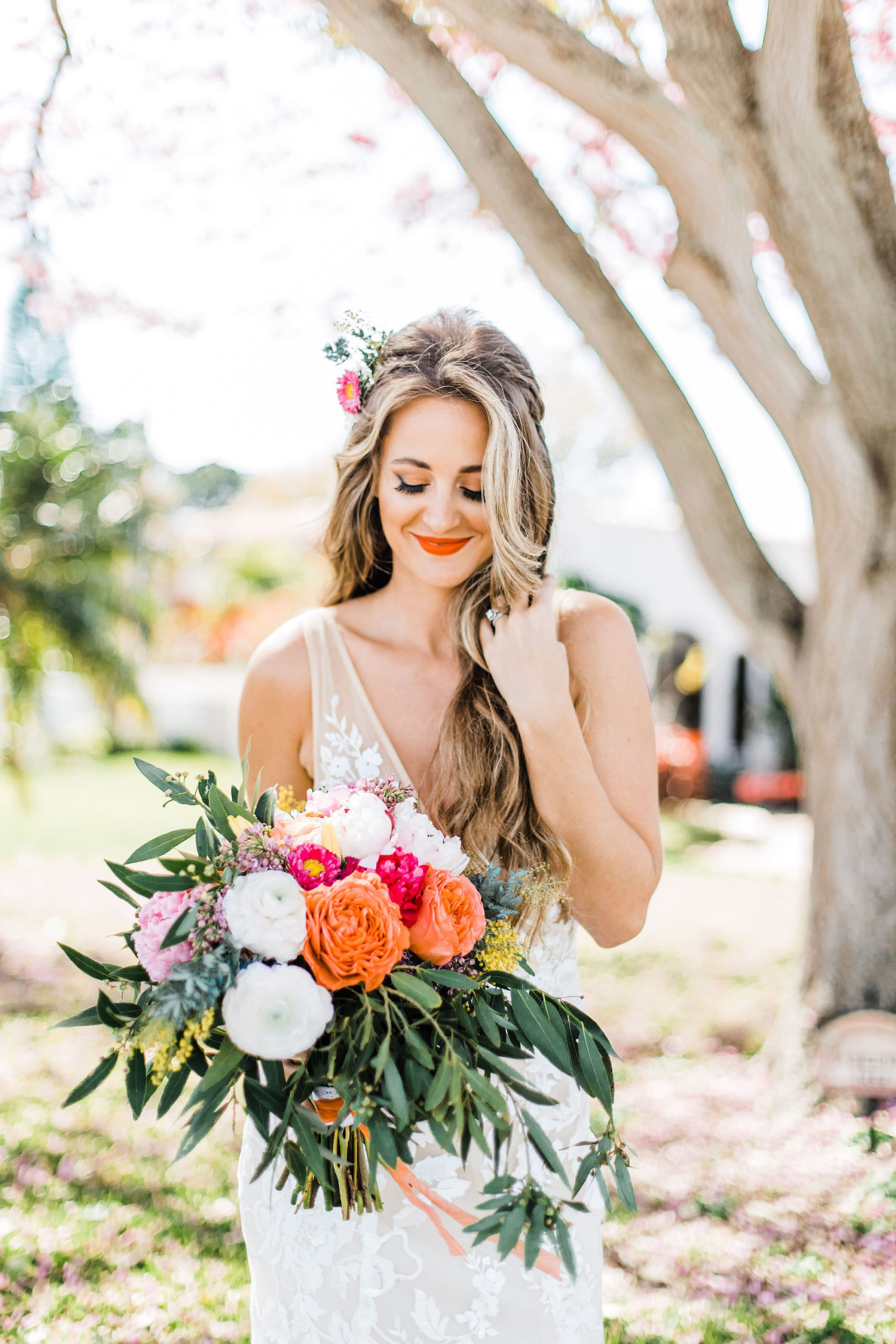 Boho Inspired Outdoor Bridal Portrait with Whimsical Colorful Bouquet and Bright Lip Color with Natural Waves and Flowers in Hair