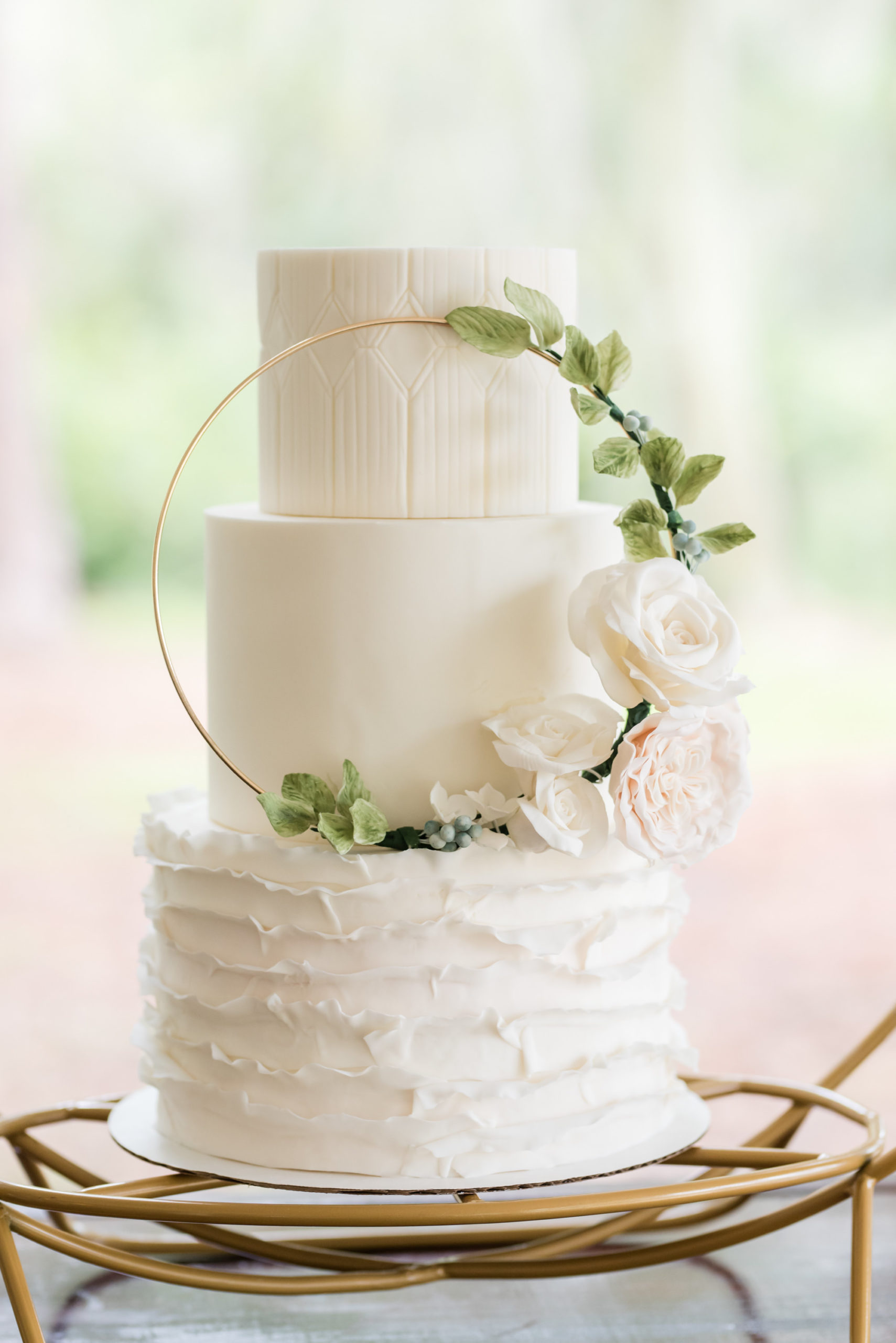 Dusty Rose Styled Wedding Shoot, Three Tier White Ruffled Bottom Tier Wedding Cake with Gold Circular Ornament with Greenery Leaves, Blush Pink and White Roses | Tampa Bay Wedding Planner Elegant Affairs by Design | Wedding Baker Tampa Bay Cake Company