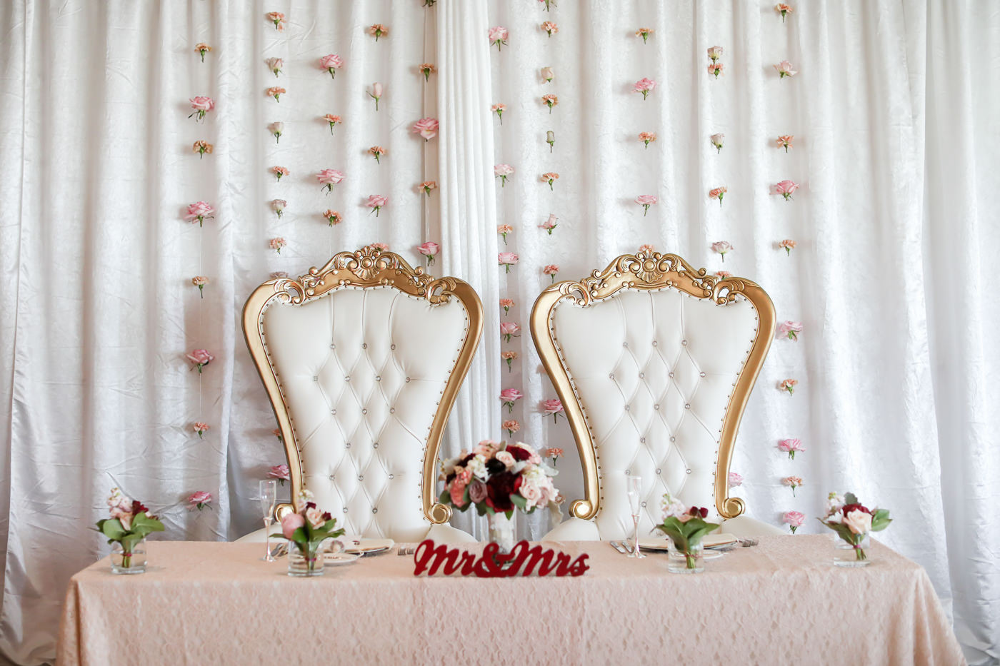 Romantic Antique Gold and Ivory Cushion Chairs, Sweetheart Table with Dusty Rose Table Linen, Red Mr and Mrs Sign, White Draping with Blush Pink Hanging Flowers | Wedding Photographer Lifelong Photography Studios | Tampa Bay Wedding Planner Blue Skies Weddings and Events | St. Petersburg Hotel Wedding Venue The Birchwood | Over the Top Rental Linens